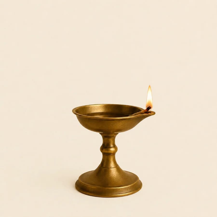 A lit traditional brass oil lamp